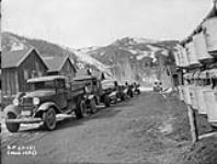 (Relief Projects - No. 61). Camp trucks lined up at noon hour Mar. 1935