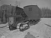 (Relief Projects - No. 103). Tractor hauling caboose to camp Sept. 1935