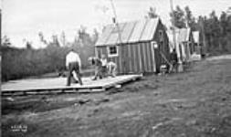 (Relief Projects - No. 156). [Constructing huts] Sept. 1935