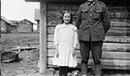 Gunner Perryman, 68th Battery, R.C.A. with peasant girl, Northern Russia, c. May 1919 May 1919