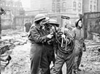 Personnel of the Canadian Women's Army Corps (C.W.A.C.) taking part in a firefighting exercise, London, England, 28 February 1943 February 28, 1943.