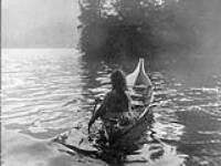 A Clayoquot medicine-woman seeking a solitary place in which to perform her rites of bodily purification 1916