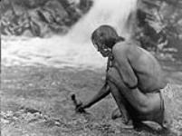 A feather offering is deposited at a shrine by a waterfall, for the purpose of winning the favor of the cloud-gods; Nambé, [a Tewa village, in the Rio Grande Valley, New Mexico] 1926