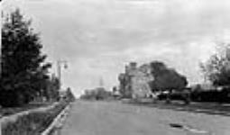 84th Avenue, looking east from 106th Street. (Right: High School, Catholic Church, City Hall, Baptist Church, Church of England - Left: Presbyterian Church) ca. 1905-1931
