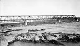 First train to cross Hudson's Bay Railway Bridge over Nelson River at Kettle Rapids, Man