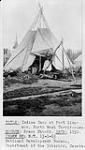 Dehcho First Nations girl standing outside of a tipi (tepee/teepee), Fort Simpson, Northwest Territories 1930