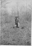 Indian medecine man gathering plants (for compounding medecine), Six Nations Reservation c.a. 1930