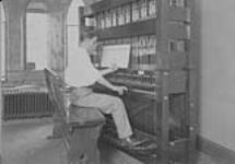 Carillon, Peace Tower, (Parliament Buildings, Ottawa, Ontario) Mr. Price, Carillonneur at keyboard
