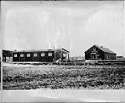 Q.M. Stores (left) and the Hardware Store (right) [at an internment camp] ca. 1915-1918