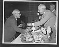 [F.X. "Moose" Goheen (left) being inducted into the Hockey Hall of Fame by Clarence Campbell.] n.d.