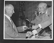 Frank Foyston (left) being inducted into the Hockey Hall of Fame by Clarence Campbell n.d.