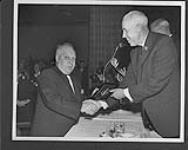 Frank Dilio (left) being inducted into the Hockey Hall of Fame by Clarence Campbell n.d.