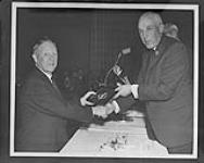 [Angus Campbell (left) being inducted into the Hockey Hall of Fame by Clarence Campbell.] n.d.