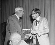 [Bruce Kidd (right) being inducted into the Canadian Sports Hall of Fame by Harry Price. 1968.] 1968