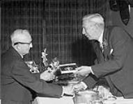 [Capt. Angus Walters (left) being inducted into the Canadian Sports Hall of Fame by Harry Price. 1962.] 1962