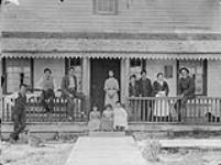 [Possibly a Métis family and their farm hands] [graphic material] c.a.1890.