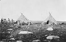 Group of Inuit and a surveyor with two tents in a landscape, [possibly the Northwest Territories] [August 18, 1894]