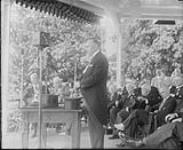 Rt. Hon. R.B. Bennett, Prime Minister, delivering a speech at an unidentified event. Note the presence of the microphone of Radio Station CKGW of Toronto ca. 1931 - 1934