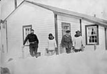 Hudson Strait Expedition. Royal Canadian Mounted Police (R.C.M.P.) personnel with Eskimos, Port Burwell, Quebec [Nunavut], 1928 1928.