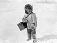 [Unidentified Inuk boy carrying a box with a strap over his shoulder, Kangiqsujuaq, Nunavik] Original title: Eskimo child, Wakeham Bay, Quebec 1928.