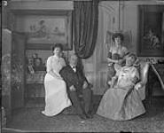 A Family Group. In Drawing-room, Residence of Sir William Mortimer Clark. - L.to R.: Lady Clark, Jean Mortimer Clark, Sir WIlliam Mortimer Clark, Elise Gordon Clark 1912
