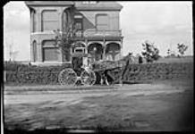 Horse and buggy in front of a house ca. 1910