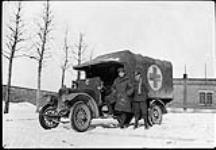 [Privates C.M. Johnston & T. Gault with C.A.M.C. ambulance,AMBULANCE Belgium, 1918.] 1918
