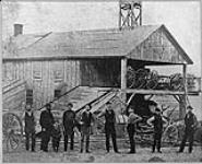 The original shop at Enniskillen, Ont. The small boy in the picture beside his father is George W. McLaughlin n.d.