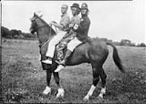 Personnel of the Royal Canadian Dragoons in clown kit riding "Bob" Aug. 1932