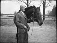 Colonel R.S. Timmis with [Arlgard], Glen Mawr Stable 27 Oct. 1952