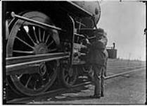 Railroad engineer oiling up an engine, 31 July, 1912 31 July 1912