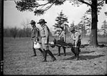 Four Boy Scouts carrying staves 25 Mar., 1911
