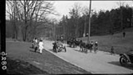 Automobile (buggies and bicycles) on new road in High Park 3 May, 1914