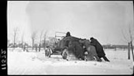 Men pushing automobile in snow 27 Dec. 1914