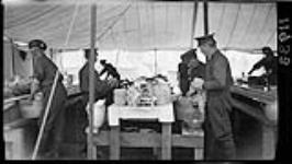 Prof. L. Miller and Gillespie washing dishes in Niagara Camp, when the C.O.T.C. (Canadian Officers Training Corps) McGill and Varsity men were there 11 May 1915