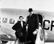 Mr. George Aiken with stewardess outside Lockheed 'Lodestar' aircraft of Trans-Canada Air Lines ca. 1940-1945