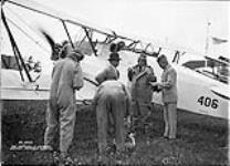 Hon. Grote Stirling (fourth from left), Minister of National Defence, preparing for flight in Armstrong Whitworth 'Atlas' AC aircraft 406 of the R. C.A.F 27 July 1935