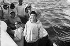 [Inuit men, bottom left Augiak Palliser, then Willia Weetaluktuk, and Peter Naluktuk in glasses] Inuit men from Inukjuak (Port Harrison), Quebec, on a boat August 15, 1944.