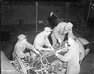 Personnel working in the motor of a plane - No. 9 Detachment 16 Nov. 1948