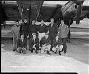 Crew posing in front of an aircraft 28 Aug. 1950