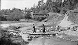 Highland Creek [with women on a timber] the bridge West Hill [Ont.] 1 Oct., 1916