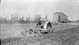 Tractor plowing near the Ontario Government, N.C. College 19 May, 1917.