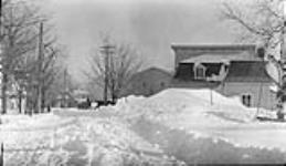Snow on street up to 2nd storey, Levis P.Q 7 Mar., 1917