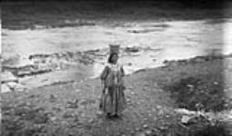 Gypsy woman carrying water at a camp on the Humber River 12 Oct. 1918
