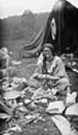 Gypsy woman peeling potatoes at a camp on the Humber River 12 oct. 1918