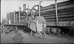 Mail carrier with wheel-barrow, Campbellville, [Ont.], 10 Oct., 1917 10 Oct. 1917