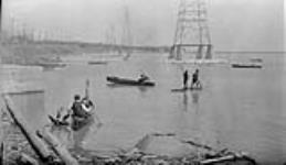 Boys on a raft and in canoes at Sunnyside Beach 7 May, 1916