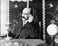 Mr. Eugenio D'Angelo at his desk in the new Italian Consulate Building, Toronto, Ontario. Fall, 1913 1913