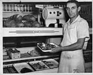 Toronto butcher holding last of his dwindling stock during National Packing House Strike, September, 1947 Sept. 1947