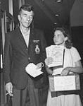 (Peace Campaign) Father and daughter collect signatures to Canadian Peace Congress postcard petition opposing Vietnam War 1965